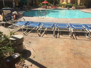 a group of chairs sitting next to a swimming pool at The Grandview at Las Vegas in Las Vegas