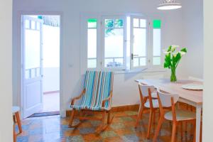 a kitchen with a table and chairs and windows at Es Badiu in Alaior +30 photos