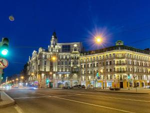 a large building on a city street at night at Heart of the City Townhouse in Saint Petersburg