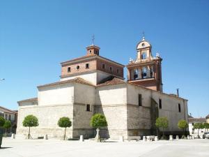 a building with a clock tower and a church at La Posada de Carmen in Chañe