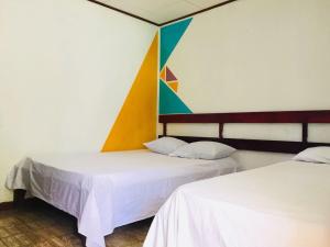 Postel nebo postele na pokoji v ubytování Cabinas Palmer Makanda