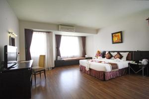 a hotel room with a bed and a television at Park View Hotel in Hue