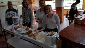 a group of people standing around a table with food at Hotel COTURPA in Papallacta +52 photos