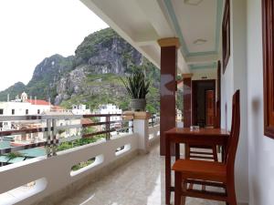 a balcony with a view of a mountain at An Binh Homestay in Phong Nha