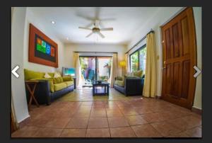 a living room with two couches and a ceiling fan at Villa Ikal in Playa del Carmen