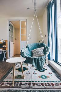 a swing in a living room with a rug at Yellow's Kenting B&B in Nanwan