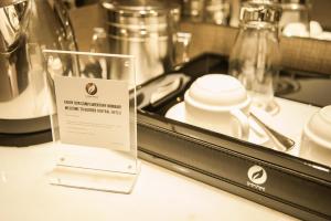 a sign sitting on top of a counter next to a table at Garden Sentral Hotel in Kuala Belait