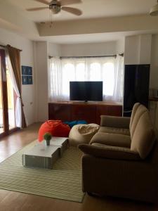 een woonkamer met een bank en een tv bij Costa Cantagay in Jagna