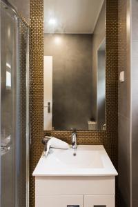 a bathroom with a white sink and a shower at Apartamento Ideal 3 in Lisbon