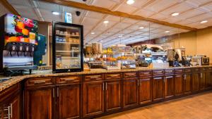 a kitchen with wooden cabinets and a counter with food at Best Western Marion Hotel in Marion