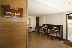 an office with a cyber cafe sign and chairs at Visual Praia Hotel in Natal +40 photos