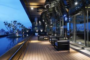 a balcony of a building with chairs and a pool at Orient Luxury Hotel in Chiayi City +34 photos