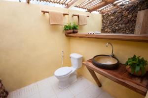 a bathroom with a toilet and a wooden sink at Mad Monkey Koh Rong Samloem in Koh Rong Sanloem