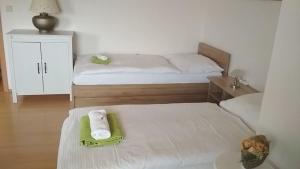 a small bedroom with two beds with towels on them at Hotel Le Café in Pohořelice