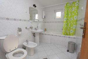 a white bathroom with a toilet and a sink at Hostel Bed&Coffee 360° in Belgrade +28 photos