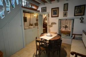 a dining room with a table and some chairs at Old Traditional House in Mandrákion