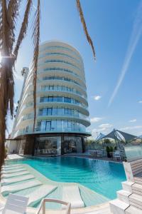 a building with a swimming pool in front of it at White Tower Mamaia in Mamaia