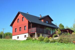 uma grande casa vermelha e branca numa colina em Chalupa Sluníčko em Cenkovice