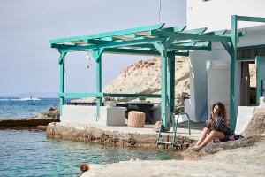 kobieta siedząca na krawędzi wody w obiekcie Terra Mare Suites w mieście Agia Irini Milos