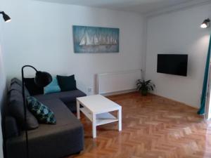 a living room with a couch and a table at Nia Apartment in Jadranovo