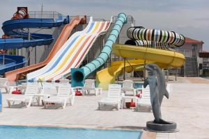 a water park with slides and chairs and a dolphin at Carpediem Diamond Hotel in Karasu