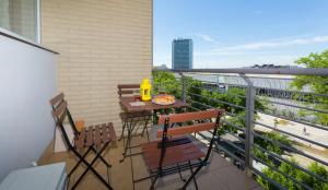 a balcony with a table and chairs on a balcony at Mentha Apartments Deluxe - MAD in Budapest