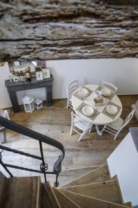 a table with plates on it in a room with stairs at Dimora Maestà in Putignano