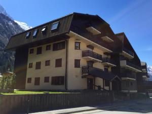 a building with a black roof and balconies on it at Les Sommets Studio in Chamonix-Mont-Blanc