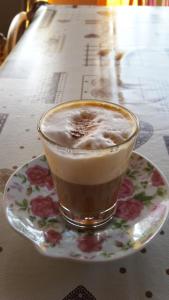 a cup of coffee on a plate on a table at Villa Salvatore in San Leone