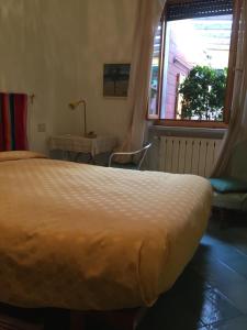 a bedroom with a large bed and a window at Casa Fornaciari affittacamere in Viareggio