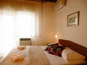 a bedroom with a bed with two towels on it at Bed and Breakfast Ivona in Baška Voda +45 photos