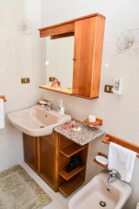 a bathroom with a sink and a mirror at Casa Noto in Marettimo