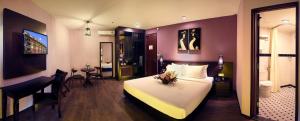 a hotel room with a bed and a desk and a bedroom at Kimberley Hotel Georgetown in George Town