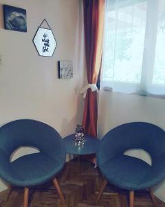 
a room with two chairs and a table at House Dado in Jezerce
