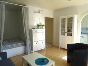 a living room with a bed and a dresser at Ferienwohnung Robbe in Bremerhaven
