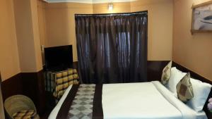 เตียงในห้องที่ Hotel Payal