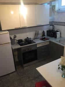 a kitchen with a sink and a stove top oven at Casa da Joana! in Murça