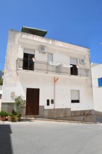 un edificio blanco con balcón en la parte superior en Casa Noto, en Marettimo