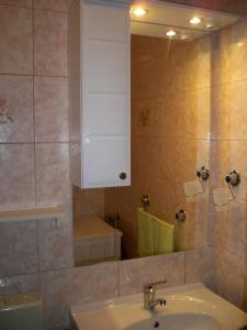 a bathroom with a sink and a mirror and a toilet at Apartmani Perkovic in Baška Voda +29 photos