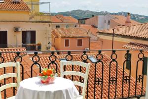 a table with a bowl of fruit on a balcony at AHR Leonis Residence La Maddalena in La Maddalena