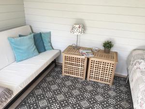 a porch with a couch and a table at Heltoften Bed & Breakfast in Nykøbing Mors