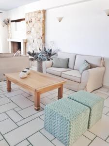 a living room with a couch and a coffee table at Saint George Hotel in Chrissi Akti