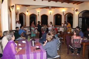 a group of people sitting at tables in a restaurant at Douar Noujoum in Essaouira