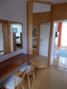a dining room with a table and two chairs at Liliom Apartments Balatonfüred in Balatonfüred