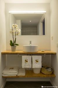 a bathroom with a sink and a mirror and towels at Hotel Secrets Priorat in Falset