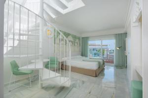 a bedroom with a bed and a staircase in it at Iberostar Selection Marbella Coral Beach in Marbella