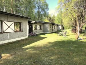 a house with a yard with chairs and tables at Raita House in Savonlinna