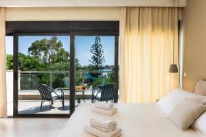 a bedroom with a bed and a view of a patio at Villa Ismini in Kato Daratso +44 photos