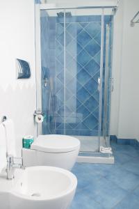 a bathroom with a sink, toilet and bathtub at Hotel Cutimare - Aeolian Charme in Acquacalda