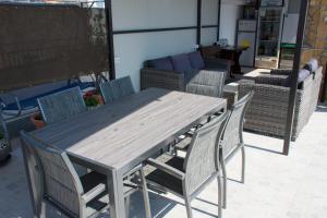 a wooden table and chairs in a living room at Apartment Baćo in Split
